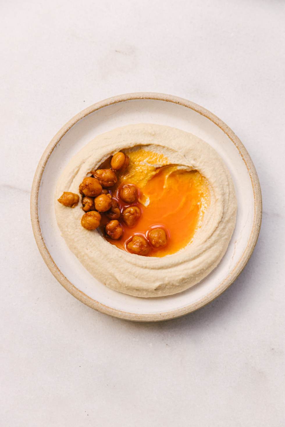 Humus with fried chickpeas and paprika oil