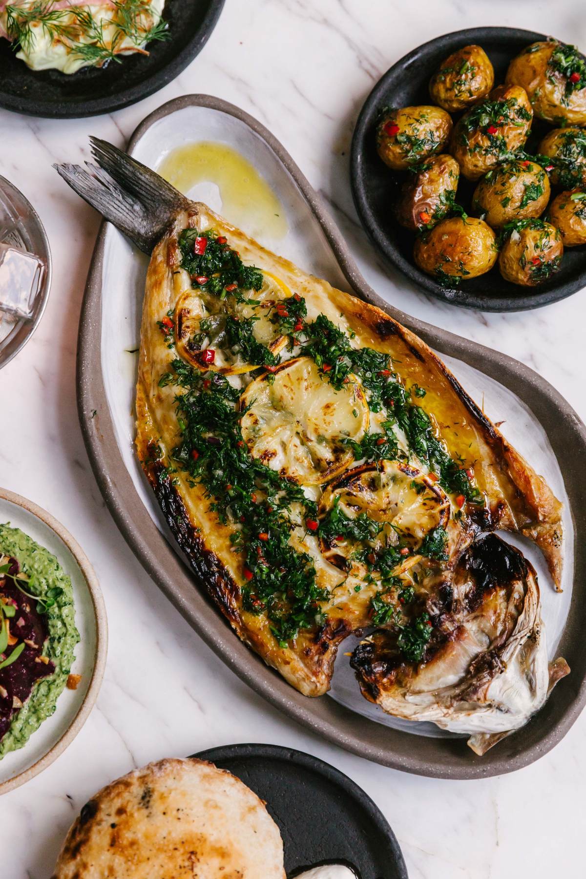 Whole grilled sea bass with herbs